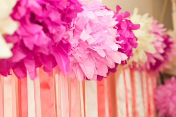 Wall Mural - decorated background for girl's birthday from pink pompoms and ribbons
