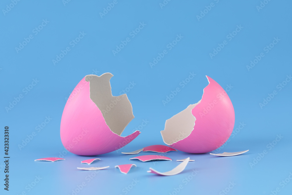 Pink Easter egg cracked open and broken into pieces. - obrazy, fototapety, plakaty 