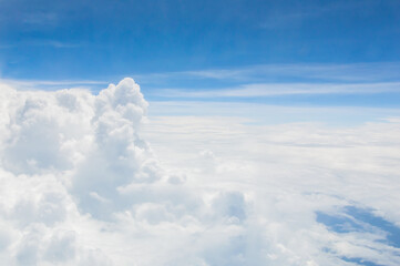 Wall Mural - over the clouds,Blue sky with tiny clouds background Beautiful natural view from airplane window above. Background or Wallpaper.blue sky and cloud sky nature.Top view of aircraft