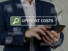  UPFRONT COSTS Text In Search Bar. Loan Officer Looking For Something At Cellphone. An upfront Cost is An Initial Sum Of Money Owed In A Purchase Or Business Venture.