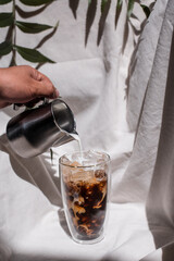 glass of coffee with milk on a white canvas