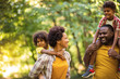 © liderina - African American family walking trough park.