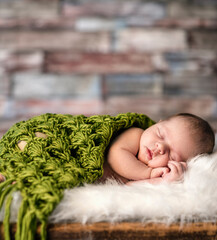 Wall Mural - cute newborn baby sleeping on rustic  suitcases