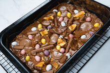 Home Baking Easter Concept. Brownie With Chocolate Bars, Mini Easter Eggs And Biscuits Baked In. Chocolate Feast Home Baked Treat