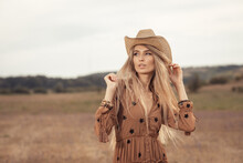 Girl In A Bohemian Style In The Steppe. Blonde Girl With A Hat On The Prairie.