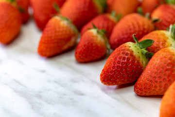 still life with strawberries on a white patterned background