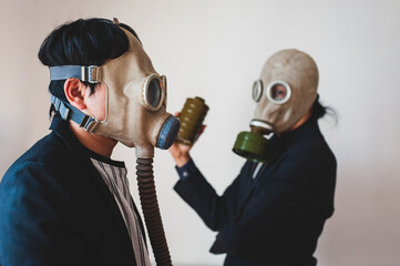 Two businessmen wearing protective masks on gray background.