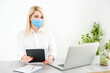 © Angelov - Young business woman working from home, wearing protective mask