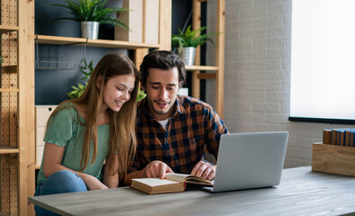 Wall Mural - Father And Teenage Daughter Looking At Laptop Together