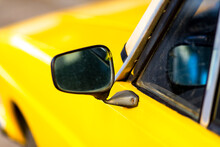 Side Mirror Details Of An Antique Yellow Car