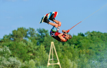 Wall Mural - Wakeboarder surfing across a lake