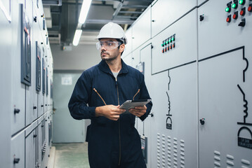 Professional engineer checking machine walk through giant motor food freeze Manufacturing Factory. Large Industry Caucasian white wearing safety vest take note maintenance of machines in the factory.