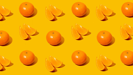 Fresh citrus Seamles fine pattern. Ripe fruit tangerines. Trendy sunlight Summer pattern made with mandarine slice on bright light orange background. Minimal summer concept. Monochromatic Banner