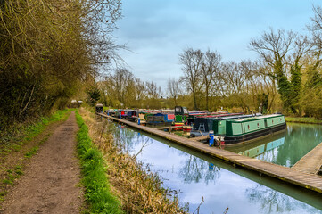 Wall Mural - A view across a canal mooring on the Grand Union Canal close to Welford, UK on a spring day