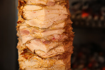 Wall Mural - Vertical rotisserie with roasted meat, closeup view