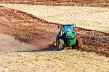 Tractor plowing land to plant sugar cane