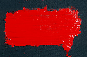 abstract creative background: red spots, strokes and splashes of colored primer when toning a black canvas, a temporary object.