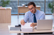 © Elnur - Young male accountant working in the office