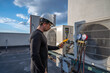 © spatesphoto - HVAC technician checking amperage