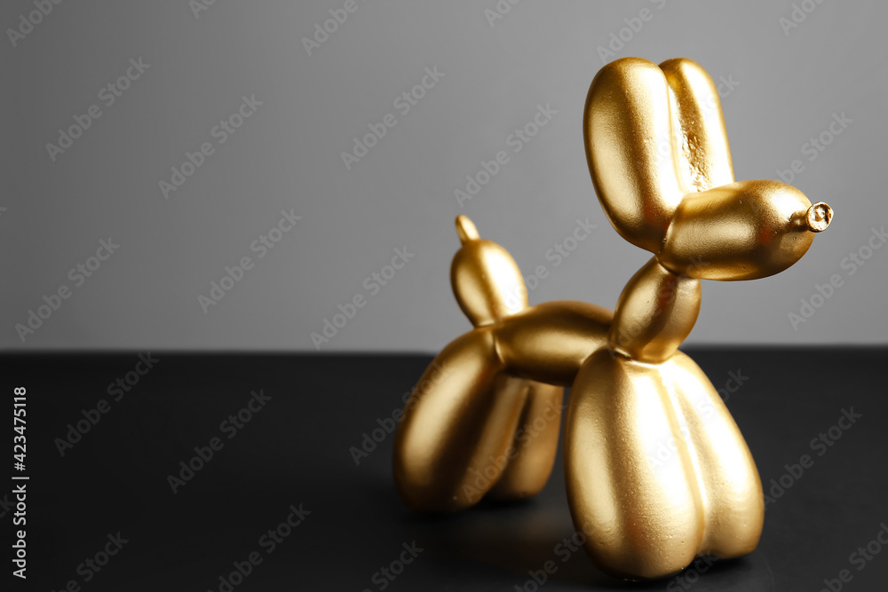 Stylish figurine of balloon dog on grey background