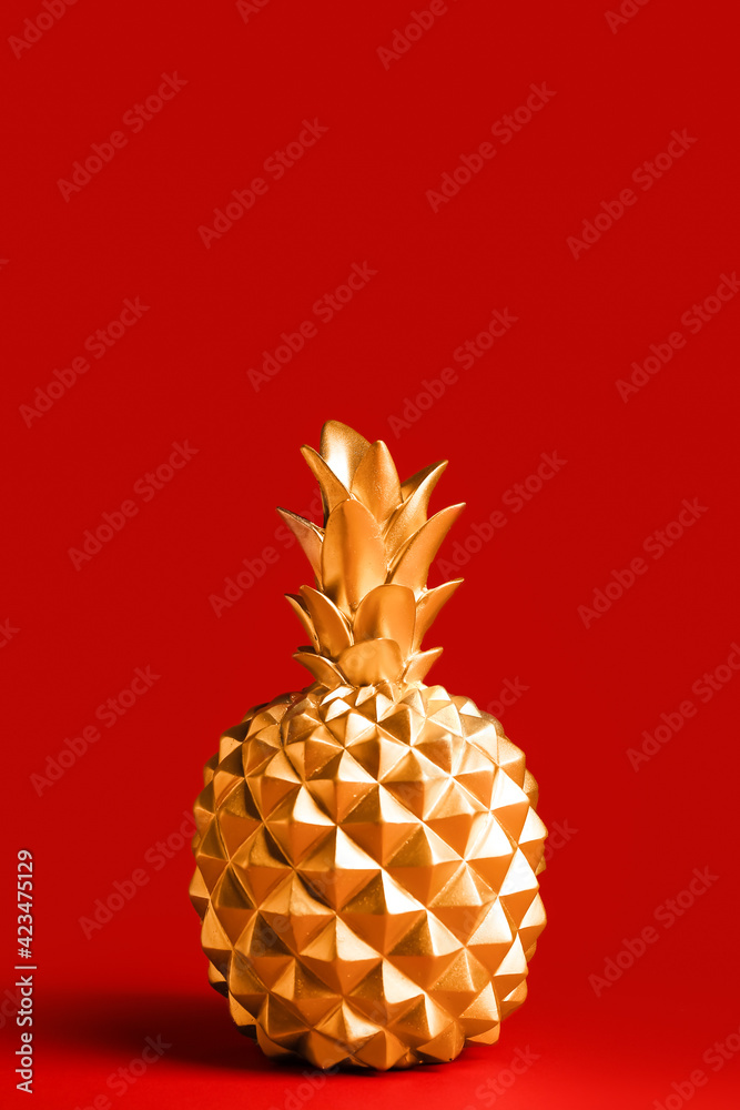 Stylish golden pineapple on color background