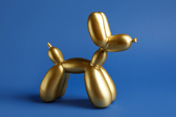 Stylish figurine of balloon dog on color background