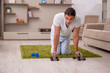 © Elnur - Young man doing sport exercises at home