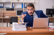 © Elnur - Young businessman employee in time management concept