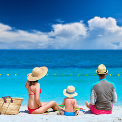 Wall Mural - Family on beach. Toddler playing with mother and father.