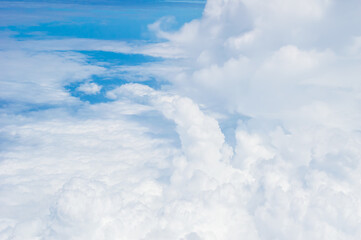 Wall Mural - over the clouds,Blue sky with tiny clouds background Beautiful natural view from airplane window above. Background or Wallpaper.blue sky and cloud sky nature.Top view of aircraft