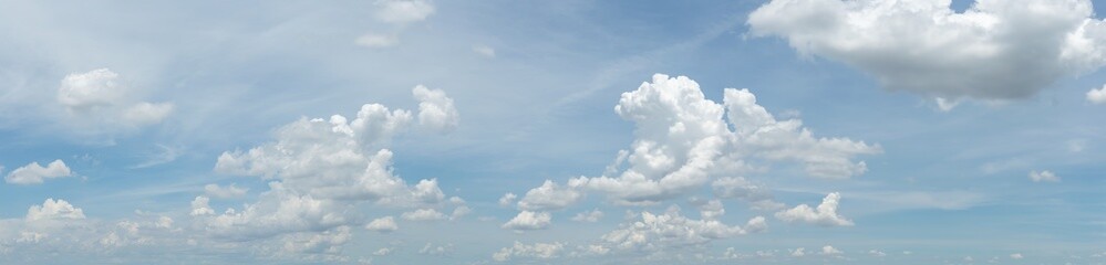 Wall Mural - blue sky background with tiny clouds. panorama white fluffy clouds in the blue sky.Beautiful vast blue sky with amazing cloud background.Wide sky panorama with scattered cumulus clouds.