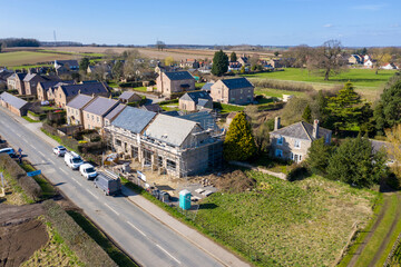 Wall Mural - Aerial photo of the UK village of Wetherby in Yorkshire showing building construction work being done on a property in the village with scaffolding up at the property