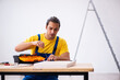© Elnur - Young male carpenter working indoors