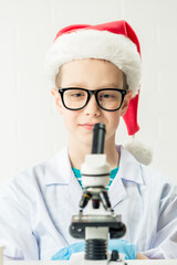 Wall Mural - student learning chemistry. positive joyful smart boy testing and using a microscope in science clas