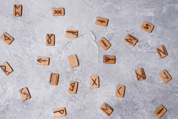 Scandinavian magic runes made of oak on concrete