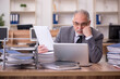 © Elnur - Old male employee unhappy with excessive work in the office