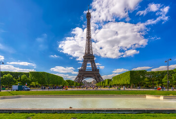 Fototapete - Paris Eiffel Tower and Champ de Mars in Paris, France. Eiffel Tower is one of the most iconic landmarks in Paris. The Champ de Mars is a large public park in Paris.