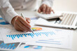 © David - Business man hands hold documents with financial statistic stock photo,discussion and analysis data the charts and graphs. Finance concept