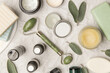 © triocean - Natural organic skin care product. Home spa and self care product top view. Facial serums, essintials oils, creams, jade roller and soap bars with copy space.