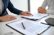 © Charlie's - Sales manager giving advice application form document, considering mortgage loan offer for car and house insurance. Real estate investment Property insurance and security. Real estate agent offer