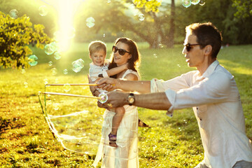 Cheerful parents enjoying summer weather with a son