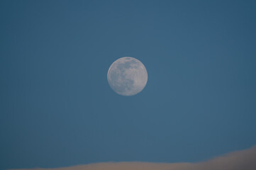Wall Mural - Big Moon with some clouds and blue sky at the afternoon