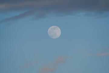 Wall Mural - Big Moon with some clouds and blue sky at the afternoon