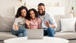 © Prostock-studio - Black family having video call using laptop waving hands