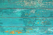 Wooden background with teal blue colored old weathered  planks with chipped paint