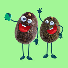 Two Avocados With Googly Eyes Taking Selfie Using Smartpone.