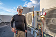© spatesphoto - HVAC technician standing next to mini split ac's