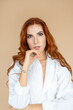 © Адель Гайнуллин - Beautiful redhead girl posing on peach color background