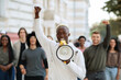 © Prostock-studio - Emotional black guy activist with megaphone on the street