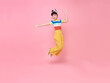 Asian child girl jumping up and wave her hands isolated on pink background.